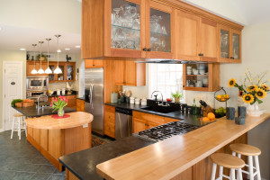 Modern gourmet kitchen featuring cherry cabinets and black soapstone.