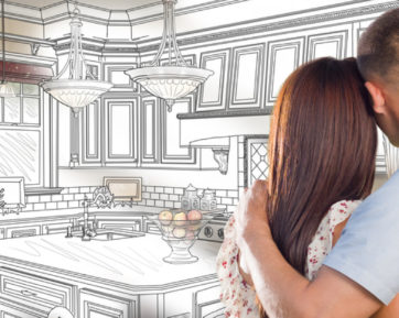couple looking at a sketch of their kitchen design